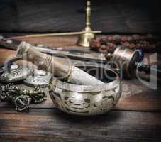 copper singing bowl and a wooden stick on a brown table