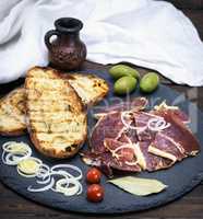 pieces of jamon and toast from white wheat bread