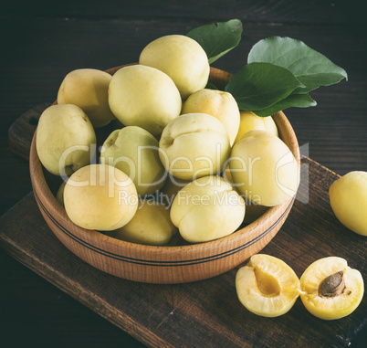 ripe apricot varieties of pineapple in a wooden plate