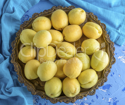 ripe apricots in a copper iron plate