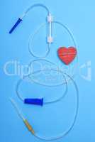 empty plastic dropper with needles and red heart