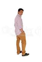 Man standing in profile in brown pants