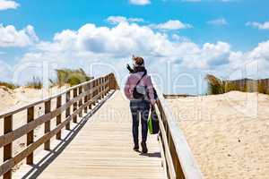 Woman on the wooden pier to the sea