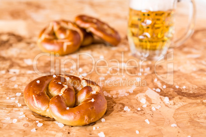 Salty cooked pretzel and lager beer