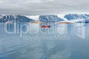 Glacier, mountains and sailing ship in Svalbard islands