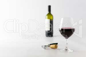 Glass of red wine and bottle