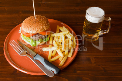 Hamburger salad and tomatoes on an earthenware plate