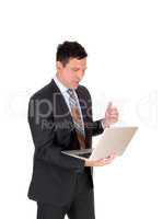 Business man reading on his laptop and is happy