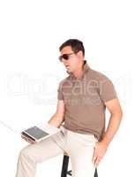 Middle age man sitting on a chair with laptop