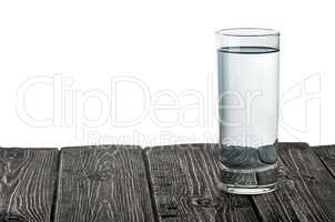 Single glass of water on wooden table