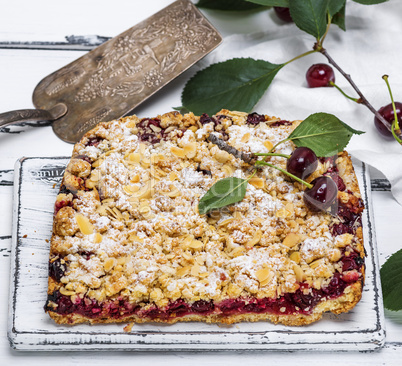 baked cake with cherries and crumbed