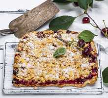 baked cake with cherries and crumbed