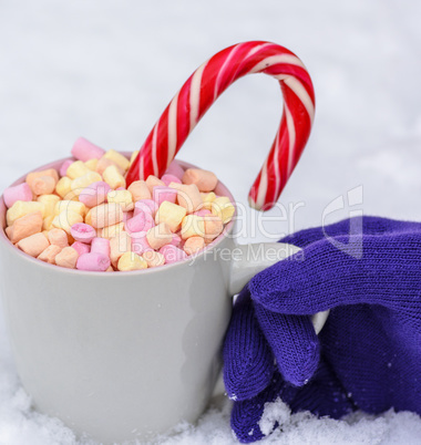 gray ceramic mug with hot chocolate slices of marshmallow