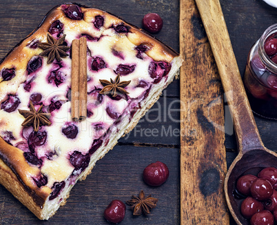 baked pie from cottage cheese and cherry berries on a brown boar