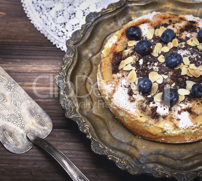 baked biscuit cake with berries blueberries on an iron plate
