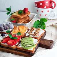 French toasts with soft cheese, strawberries, kiwi, walnuts, che