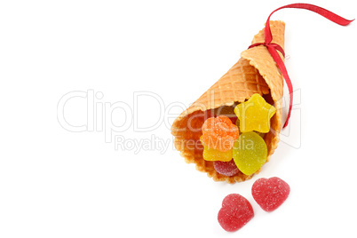 Marmalade candies in a waffle horn isolated on white background.