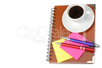 Notebook and cup of coffee isolated on white background. Free sp