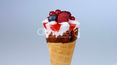 Forest fruits ice cream rotating on blue background