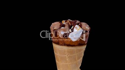 Chocolate and vanilla ice cream rotating on black background