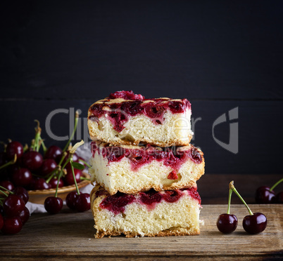 a stack of square slices of a baked pie with cherry berries