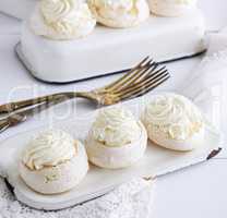 baked round puff pastry with cream on an iron plate