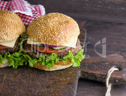 hamburger with a meat chop and a round bun with sesame