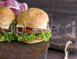 hamburger with a meat chop and a round bun with sesame
