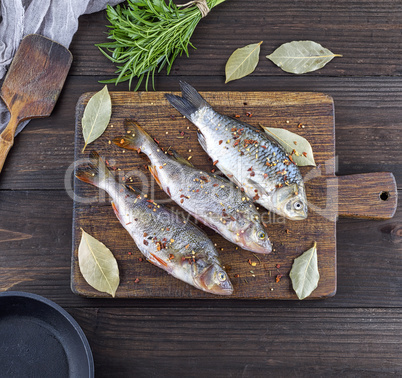 three peeled river fish with spices