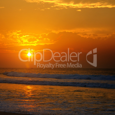 Beach of the ocean and golden sun rise.