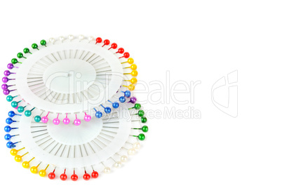 Lot of colorful pins isolated on a white background. Free space