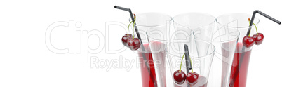 Cherry and glass of juice isolated on white background. Wide pho