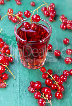 Redcurrant and glass with fruits and drink juice
