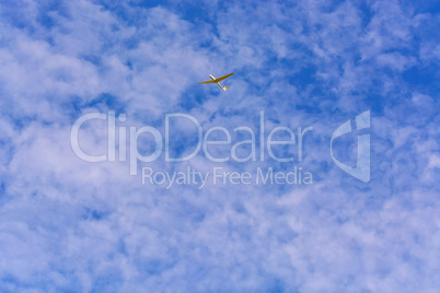Glider in front of blue sky.
