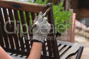 Woman hand with brush restored wooden furniture