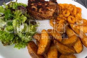 Breaded grilled meat, potatoes and vegetables