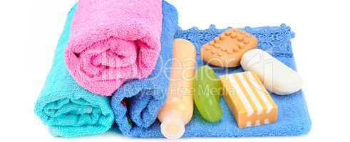 Cotton towels, cosmetic soap and shampoo isolated on white. Wide