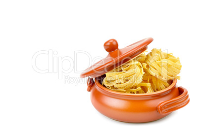 Pasta in a clay pot isolated on white background. Free space for