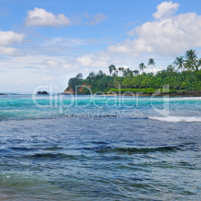 Ocean, picturesque beach and blue sky.