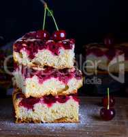 pile of square pieces of a biscuit pie with cherries