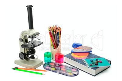 Laboratory microscope, textbook and other school supplies isolat