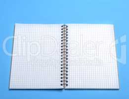 open blank notebook in a box on a blue background