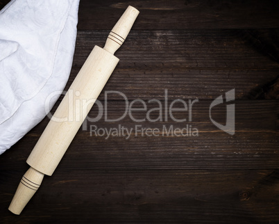 wooden rolling pin and a white textile towel