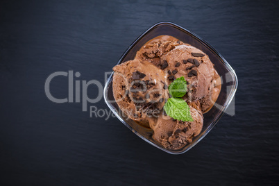 Scoops chocolate ice cream in glass bowl