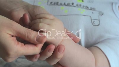 Close-up shot of baby's little cute hand in mother's hands