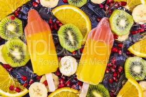 Fruit ice cream on stick with slices fruits on black