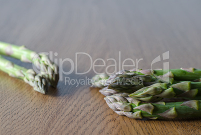 Close-up of fresh green asparagus on the  wooden background.