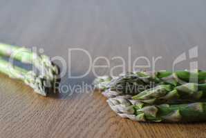 Close-up of fresh green asparagus on the  wooden background.