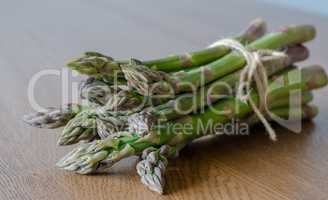 Close-up of fresh green asparagus wrapped with rope. angle view