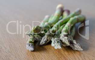 Close-up of fresh green asparagus on wooden background. angle vi